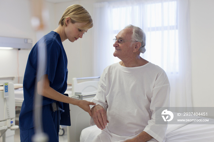 Nurse checking on senior patient in hospital room