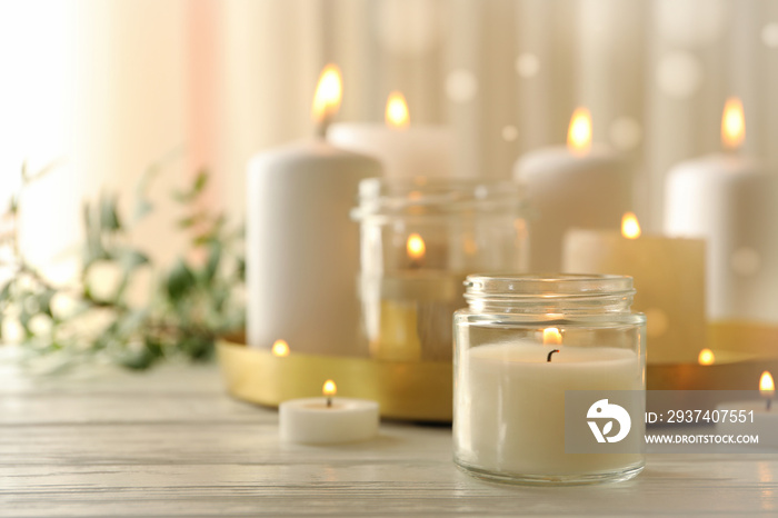 Burning scented candles for relax on white wooden table