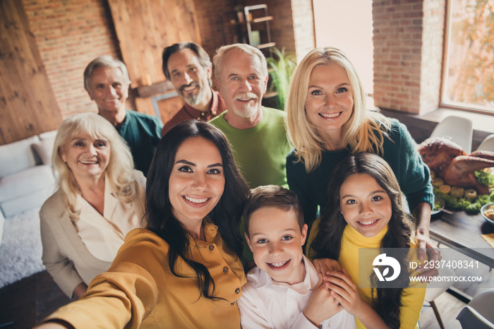 Closeup portrait photo of full family gathering eight people cuddle embrace hold hands finish dinner