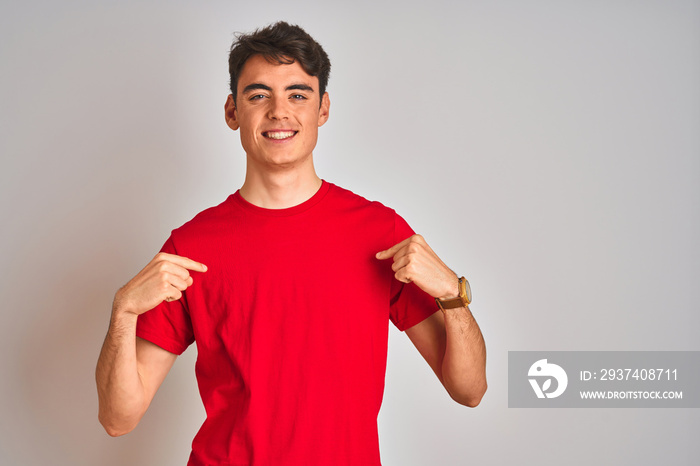 Teenager boy wearing red t-shirt over white isolated background looking confident with smile on face