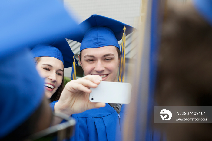 graduates taking pictures of each other