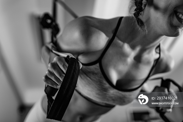 Woman exercising on TRX in the gym