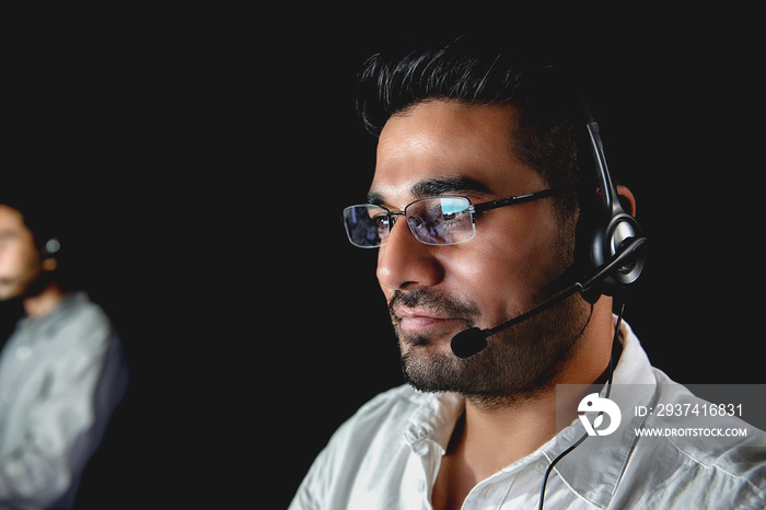 Asian male customer service  operators working night shift in call center