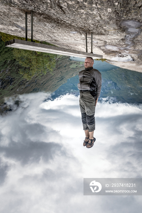 a man stands on his head on a bench inverted photo