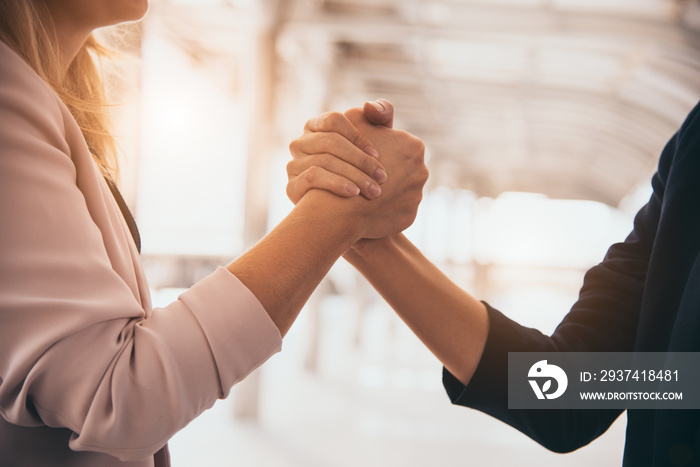 Business partnership meeting trust handshaking concept. Businesswomen doing arm wrestling. Successfu