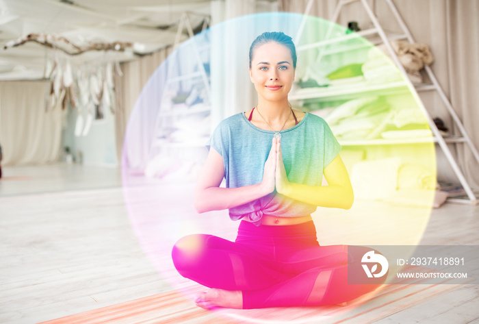 mindfulness, spirituality and healthy lifestyle concept - woman meditating in lotus pose at yoga stu