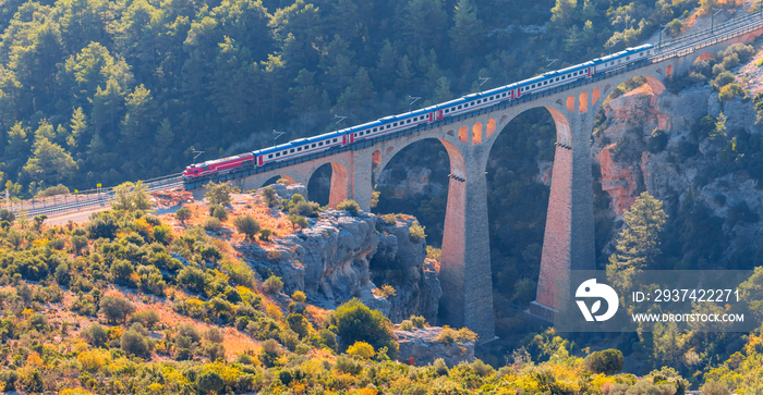 A diesel train passing over the bridge - Varda railway bridge - Adana, Turkey 