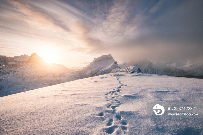 Snowy mountain ridge with footprint in blizzard