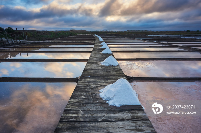 Traditional salt extraction camp (Salinas) with piles of extracted salt at sunrise - Figueira da Foz