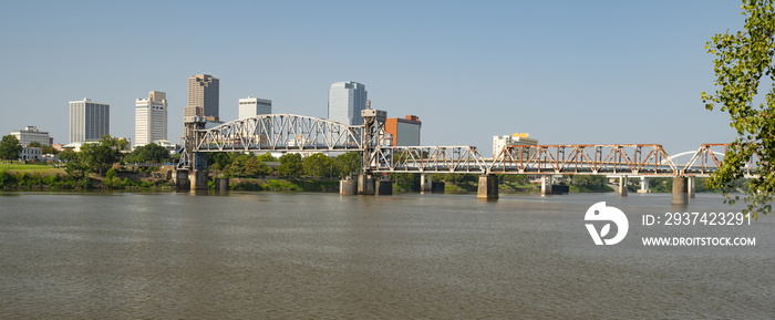 The Arkansas River flows by the Little Rock Waterfront under Bridges and Tresles