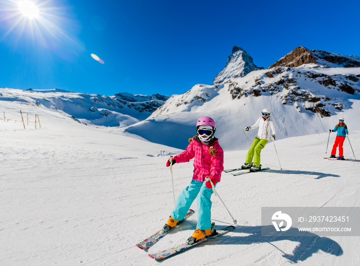 Skiing family on ski slope in Zermatt, Switzerland.