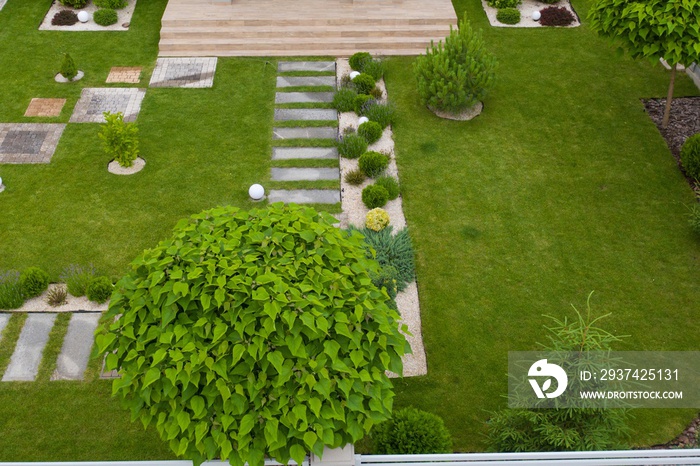 Garden with walkways and green grass. Photo taken from above drone.