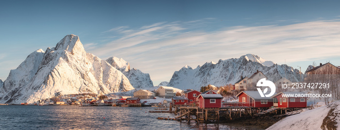 Scandinavian village with snow mountain at coastline in morning