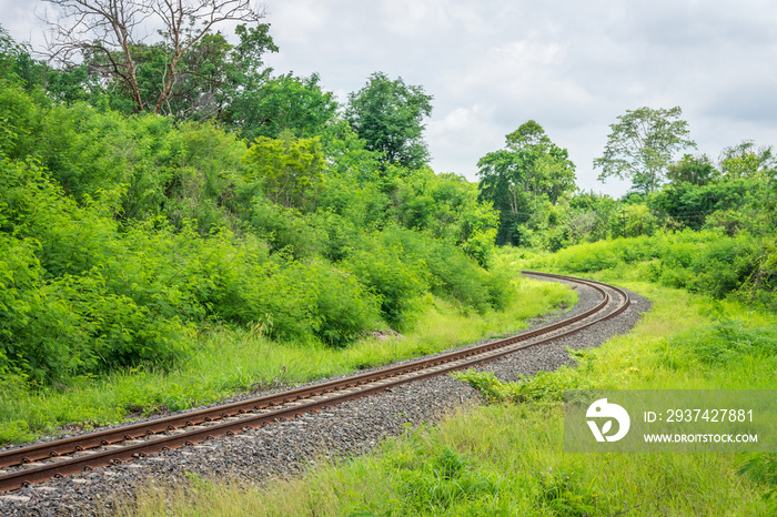 Curved single train track in forest of Thailand. With two parallel iron rails for movement of rail c