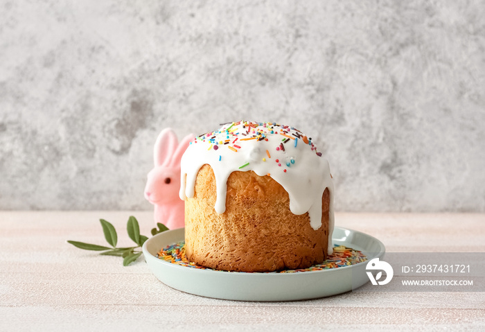 Plate with delicious Easter cake on table