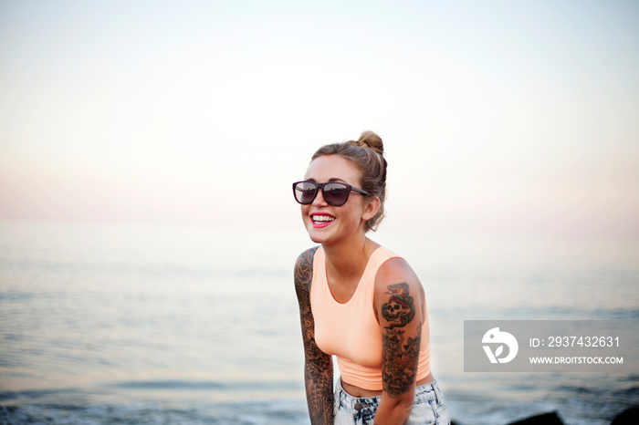 Smiling young woman standing on beach