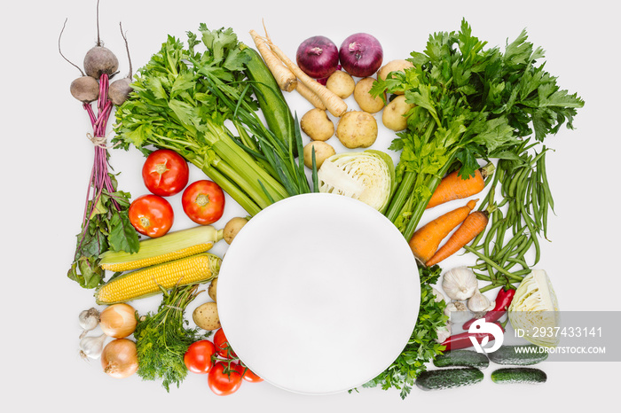 top view of food composition with fall harvest with empty plate in middle isolated on white