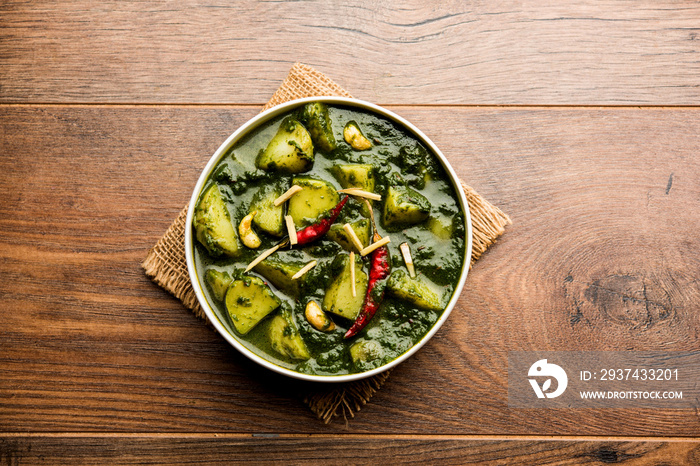 Aloo Palak sabzi or Spinach Potatoes curry served in a bowl. Popular Indian healthy recipe. Selectiv