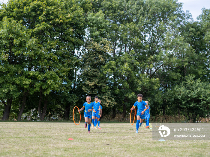 孩子们（8-9岁）穿着制服在足球场上练习