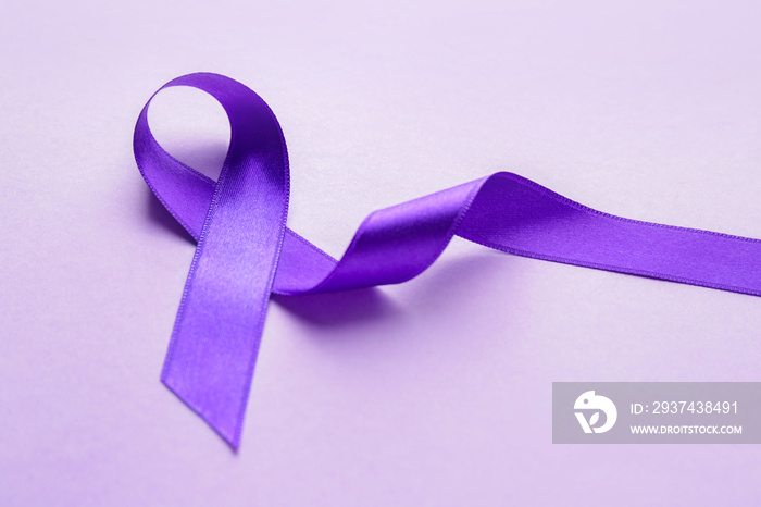 Purple ribbon as symbol of World Cancer Day on color background