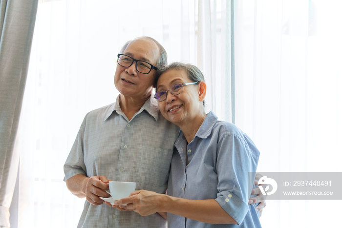 Asian senior couples standing together while they looking in front of them with smile showing they h