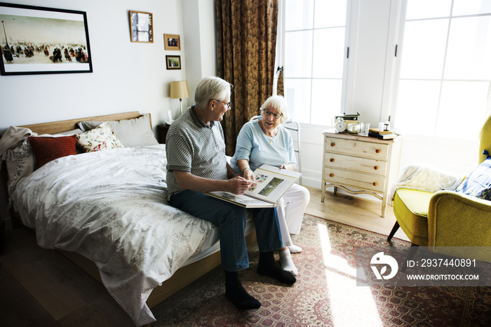 Senior couple looking at family photo album