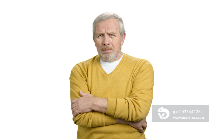 Portrait of sad old man. Sick frustrated grandpa in yellow sweater. White isolated background.