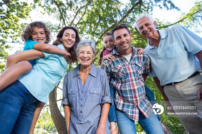 Extended family smiling in the park