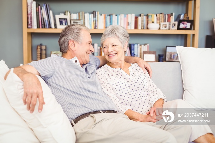 Happy senior couple sitting on sofa