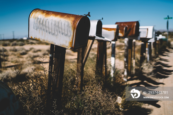 Rusty forgotten mailboxes placed in countryside