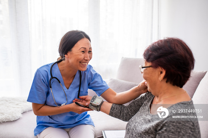 Portrait of young Asian nurse with elderly woman. Helpful volunteer taking care of senior lady at he