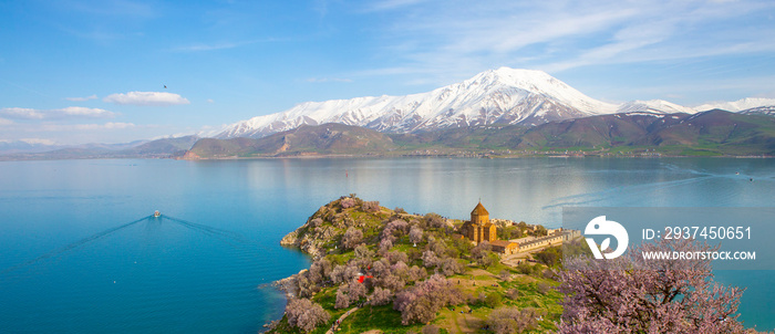 ‘Armenian Holy Cross Cathedral’ surrounded by tree in blossom, in a middle of ‘Akdamar Island’ Akdam