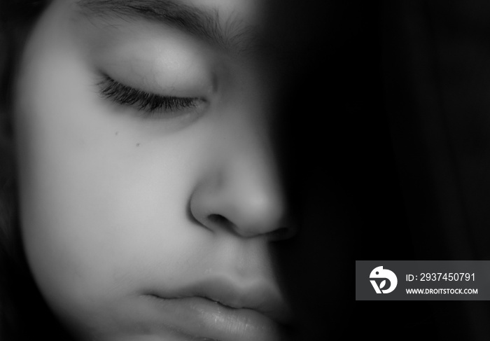 Isolated close up portrait in black and white of a young beautiful girl sleeping