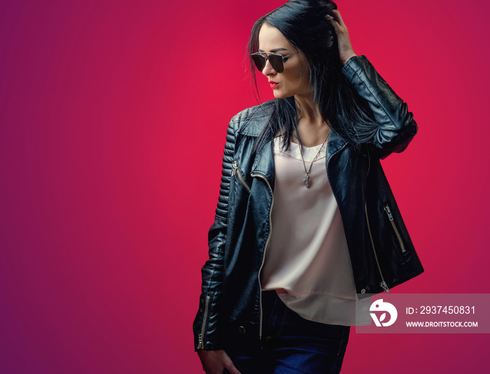 young girl with black hair in a leather jacket and stylish sungl