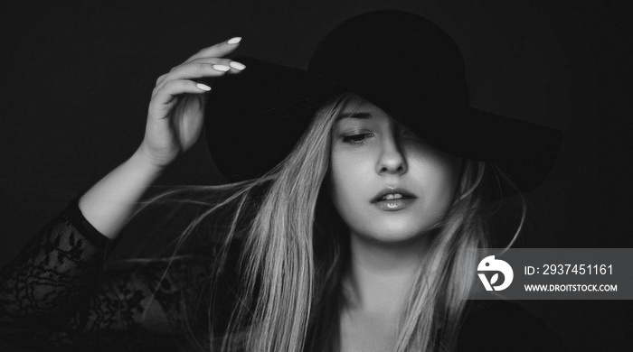 Beautiful blonde woman wearing a hat, artistic film portrait in black and white for fashion campaign