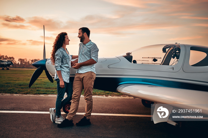 Couple in love staying near aircraft