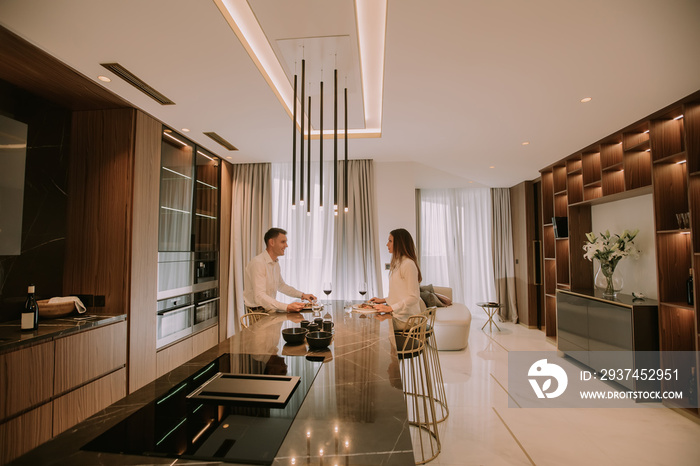 Sweet couple having a romantic dinner at luxury kitchen