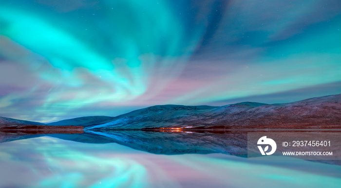 Aurora Borealis in Tromso, Norway in front of the Norwegian fjord - Winter season