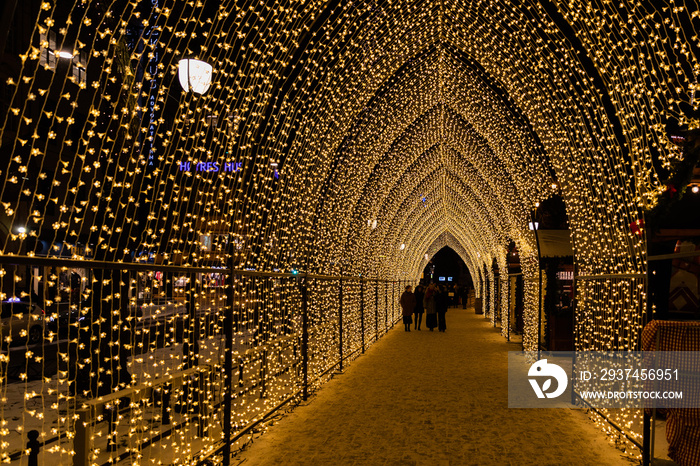 Illuminated crossing during Christmas holiday in Oslo Norway during winter all covered with fresh sn