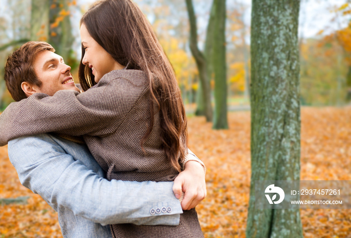 love, relationship, family and people concept - smiling couple hugging in autumn park