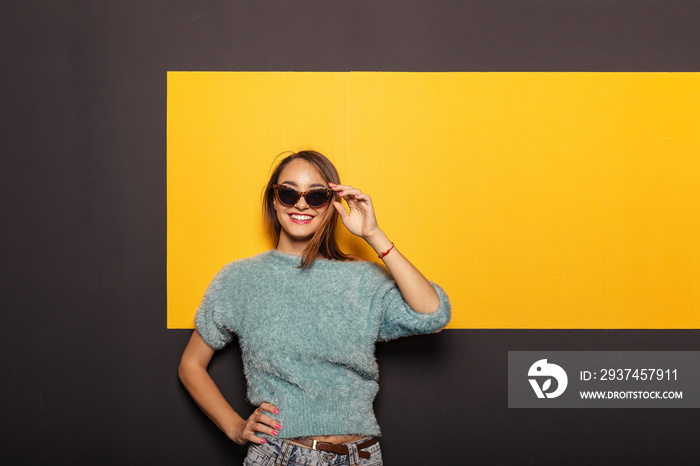 Fashion portrait of an appealing, stylish woman with sunglasses