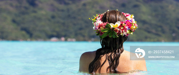 Beautiful woman wearing colorful flower crown while on a tropical island vacation in Bora Bora near 