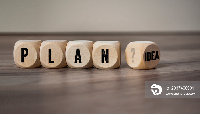 Cubes and dice with plan and idea on wooden background