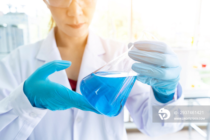 Scientists hold the chemical tubes or laboratory beaker to test values or Flask in scientist hand wi