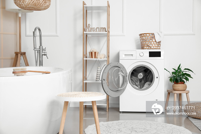 Interior of bathroom with modern washing machine