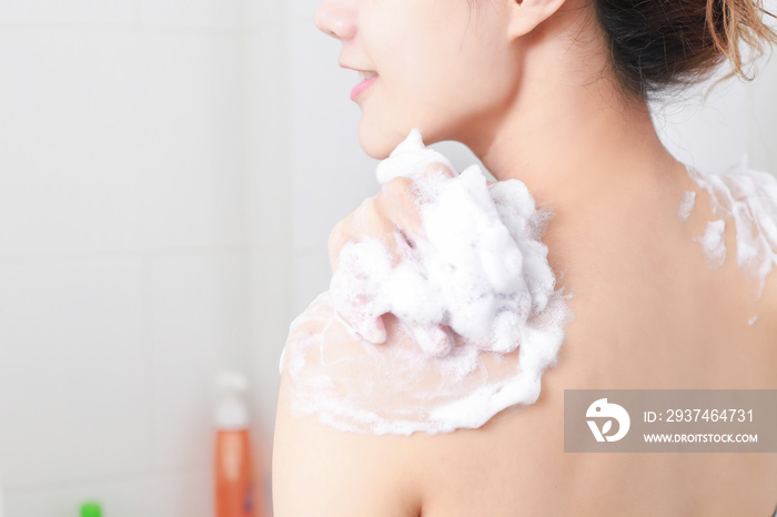 Woman taking a shower enjoying water splashing on her. selective focus