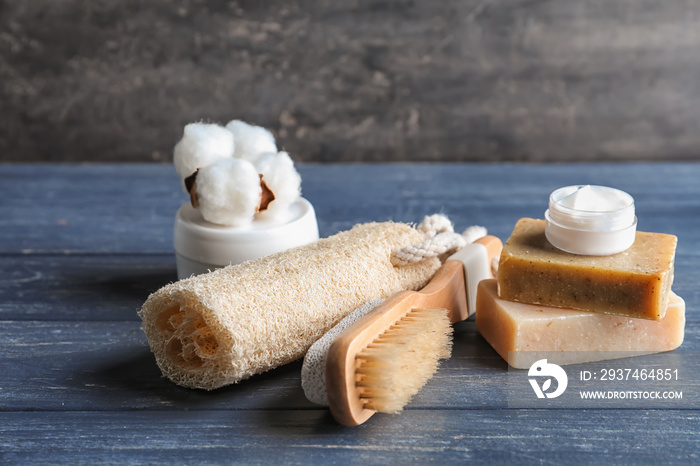 Bath products with loofah and brush on dark wooden table