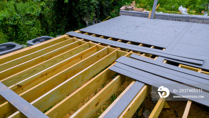 A new wooden, timber deck being constructed. it is partially completed can be seen on the decking.