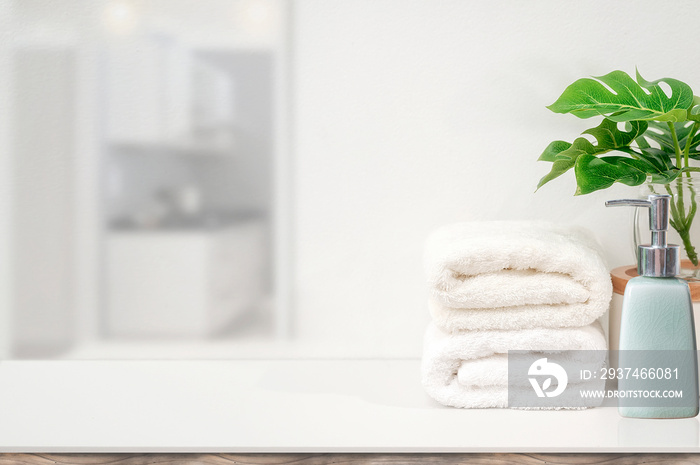 Mockup white towels and houseplant on white table with copy space for product display.