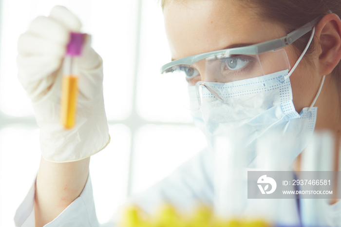 Researcher, doctor, scientist or laboratory assistant working with plastic medical tubes in modern l